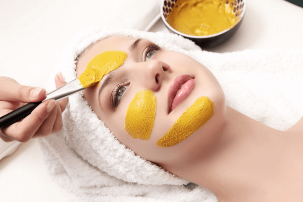 A woman with haldi face pack