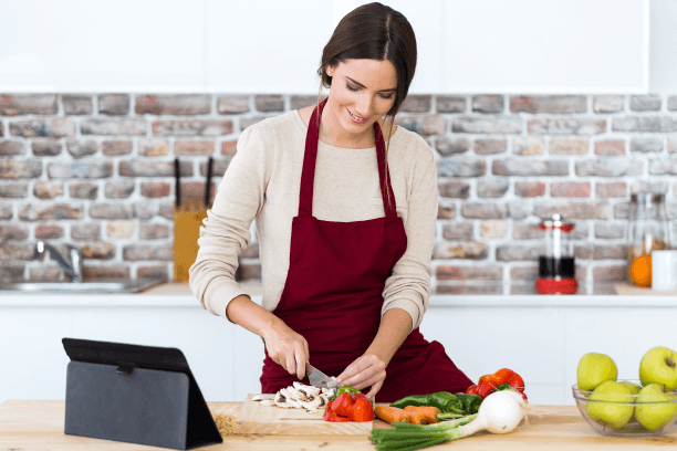 Woman cooking food happily